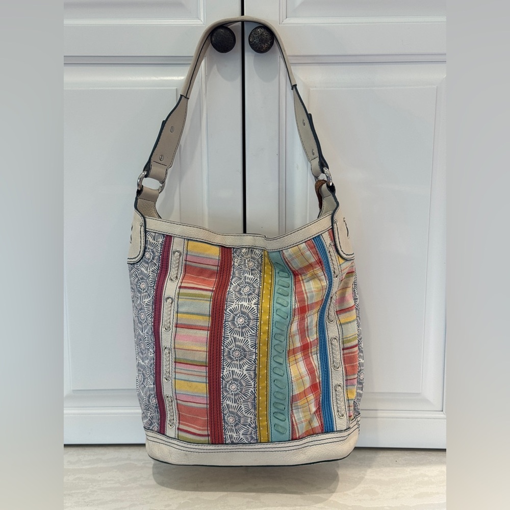 Fossil hobo style purse, cream leather handles and details.